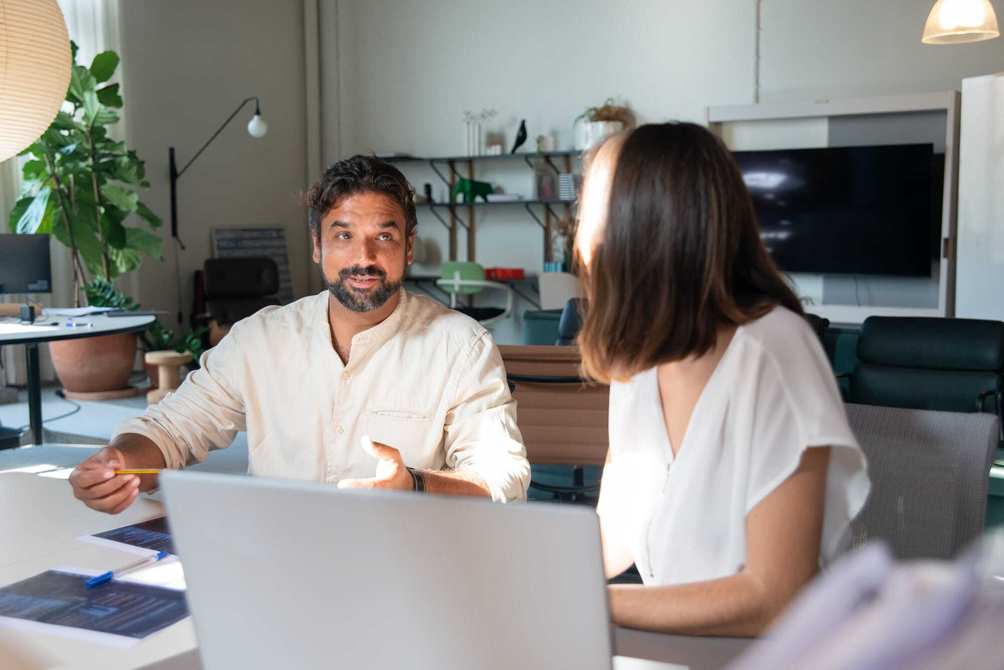 A consultant talking with a nonprofit staff member at a laptop